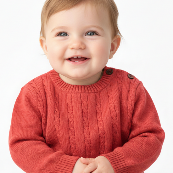 Child wearing a red sweater on a white background
