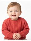 Child wearing a red sweater on a white background