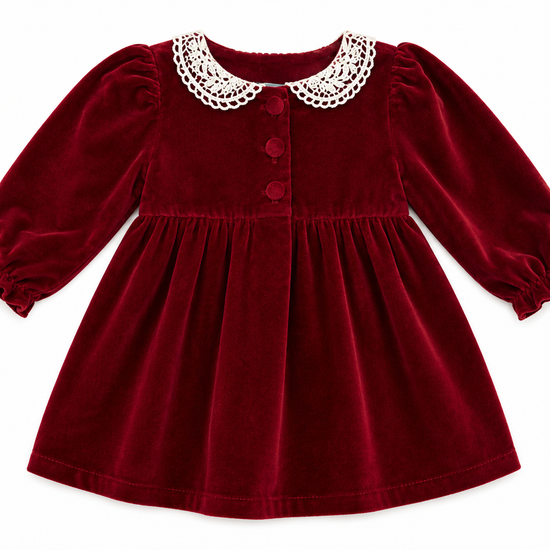 Red velvet dress with white collar on a white background