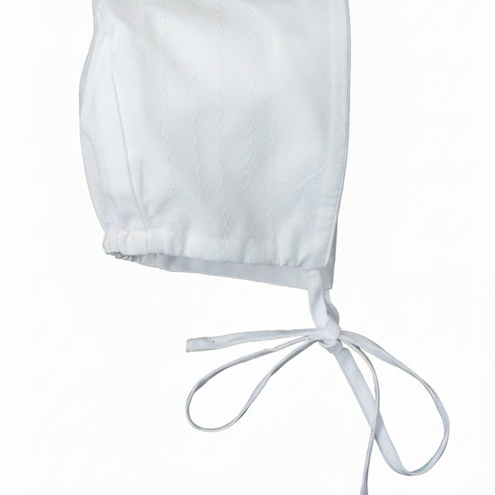 White baby bonnet on a white background