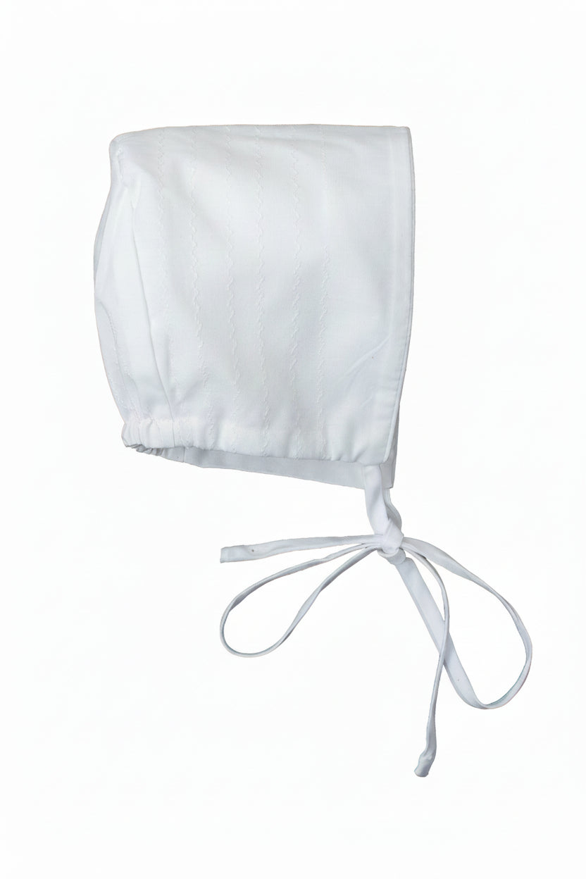 White baby bonnet on a white background
