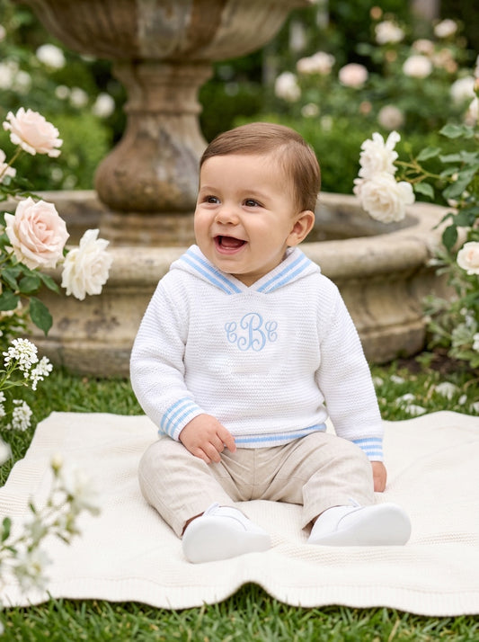 Carriage Boutique personalized white cotton hooded sweater with blue striped trim worn by a smiling baby boy