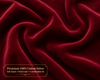 Close-up of red velvet fabric with a label indicating it is premium 100% cotton.