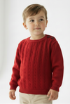 Child wearing a red sweater on a white background