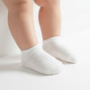 Carriage Boutique Baby Girls white cotton blend ankle socks with diamond pattern and ribbed cuff.