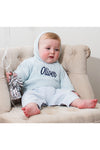 Carriage Boutique baby blue cable knit hooded sweater with navy blue Oliver embroidery, worn by a baby in a chair.