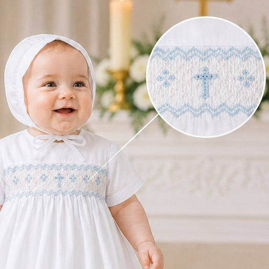 Carriage Boutique baby boy white christening gown with hand-smocked yoke featuring a baby blue bullion cross and bonnet