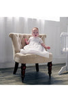 Baby boy wearing a Carriage Boutique white christening gown with hand-smocked blue cross yoke and matching bonnet