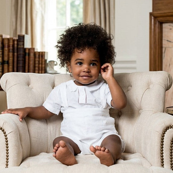 Carriage Boutique baby boy wearing a white linen cotton christening short set with hand embroidered details