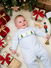 Carriage Boutique baby boy light blue longall with smocked Christmas tree embroidery on a festive holiday background