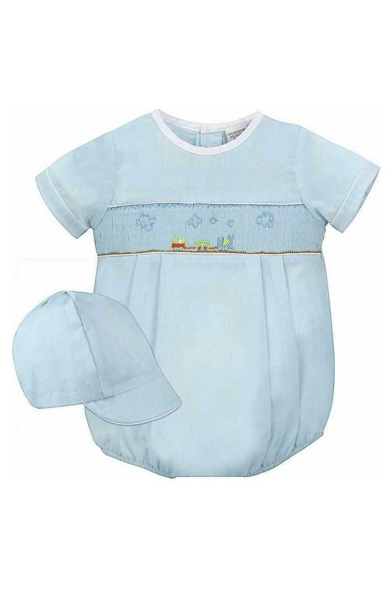 Carriage Boutique baby boy sky blue smocked bubble romper with train embroidery and matching hat.