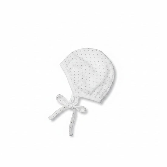 Carriage Boutique gender neutral baby bonnet in white cotton with a subtle grey polka dot print and chin tie.