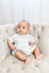 Carriage Boutique white cotton blend baby romper with grey polka dots and hot air balloon smocking.