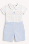 Carriage Boutique white short-sleeve bobbie suit with blue smocking, cross, and light blue shorts.