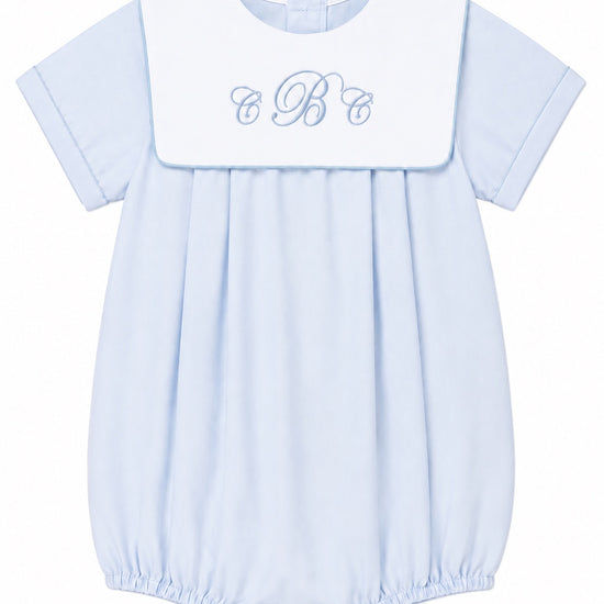 Carriage Boutique baby boy blue cotton romper with white collar and custom monogram embroidery for special occasions.