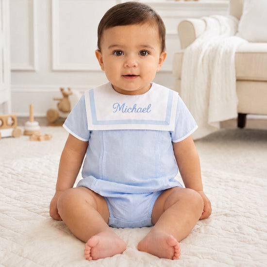 Carriage Boutique baby boy bubble romper in light blue and white with a Peter Pan collar and custom name embroidery.