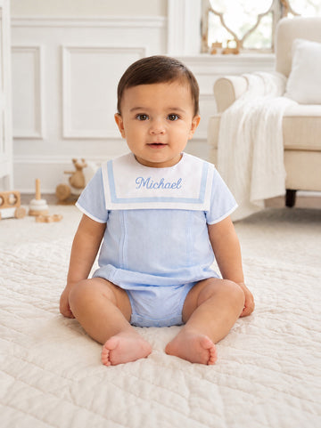 Carriage Boutique baby boy bubble romper in light blue and white with a Peter Pan collar and custom name embroidery.