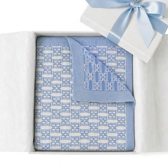 Carriage Boutique blue and white monogram knit baby blanket in a gift box with a blue satin ribbon.
