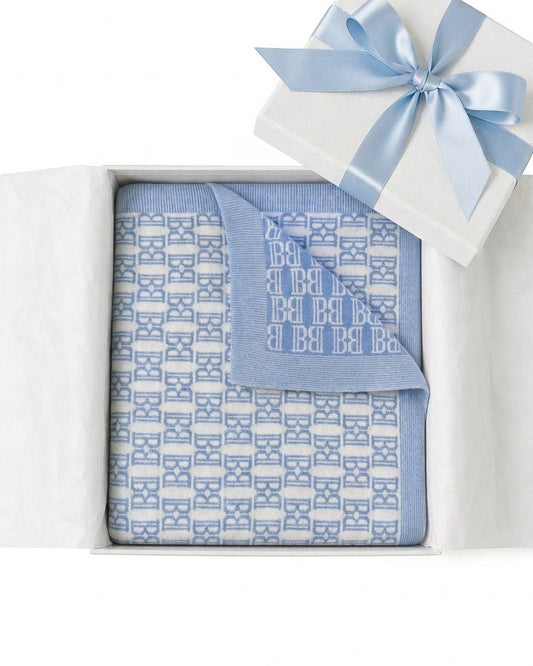 Carriage Boutique blue and white monogram knit baby blanket in a gift box with a blue satin ribbon.