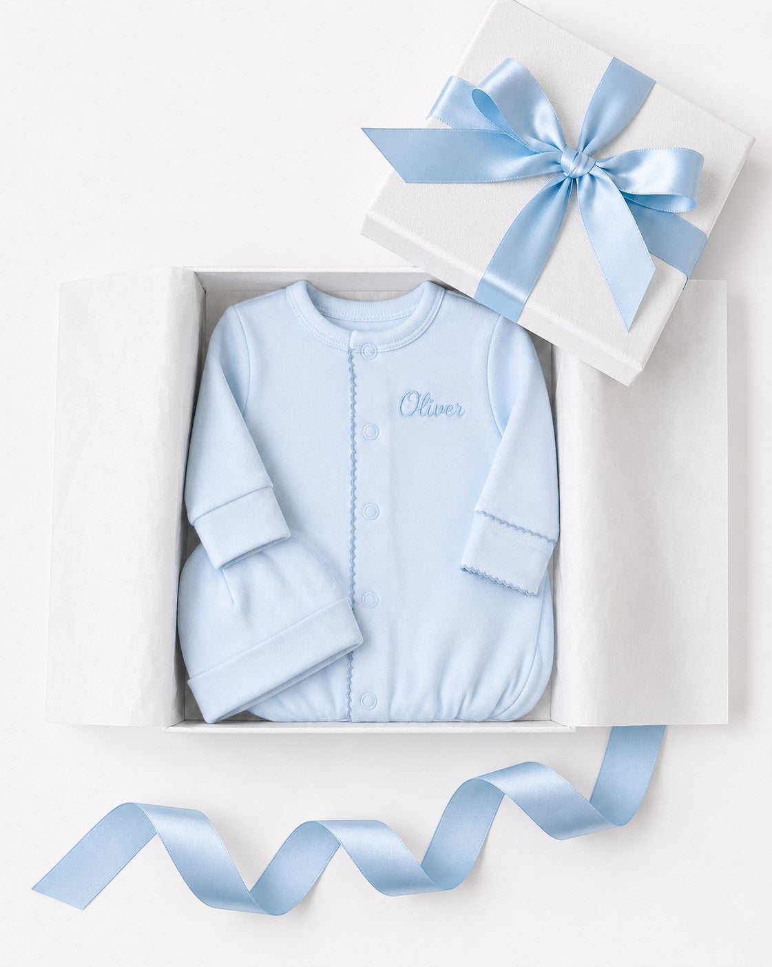 Carriage Boutique blue newborn sleep sack with matching hat and personalized embroidery in a gift box.