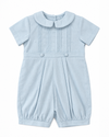 Carriage Boutique baby boy blue pique romper with a Peter Pan collar, pleated bodice, and button detailing.