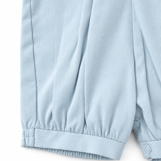 Carriage Boutique baby boy romper in light blue pique fabric with gathered leg cuffs and snap button detailing.