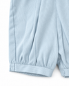 Carriage Boutique baby boy romper in light blue pique fabric with gathered leg cuffs and snap button detailing.