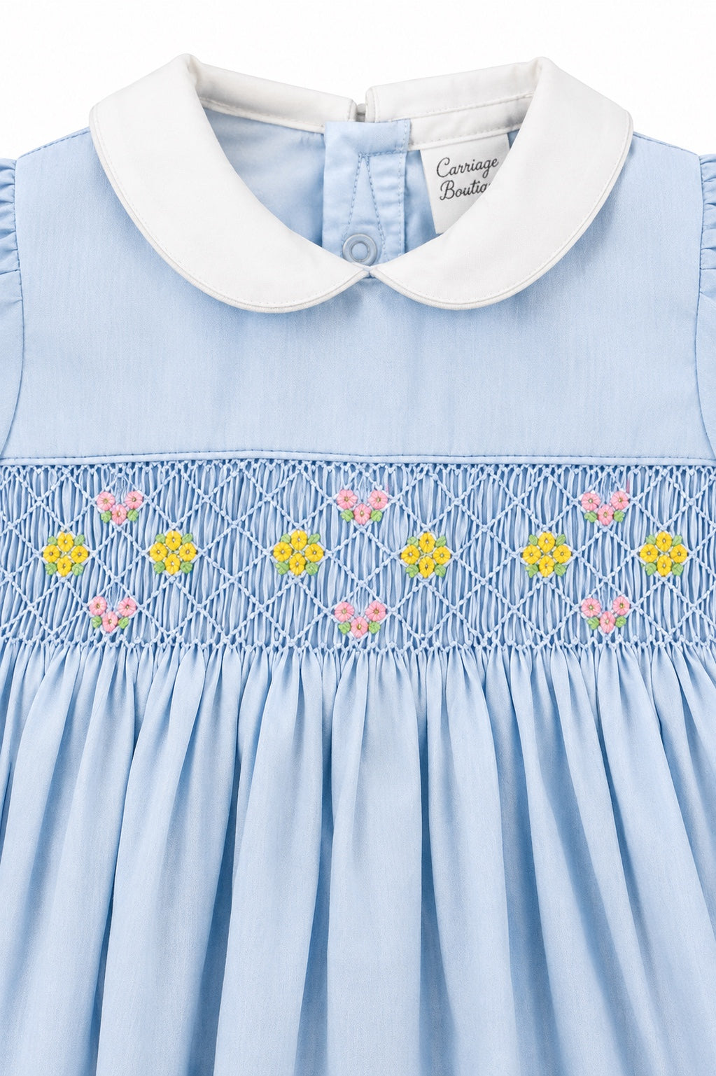 Carriage Boutique blue baby girl dress with white peter pan collar and hand-smocked waist with floral embroidery.