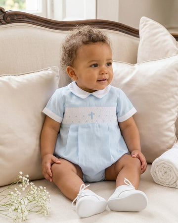 Carriage Boutique baby boy blue cotton bubble romper with hand-smocked cross detail and white Peter Pan collar
