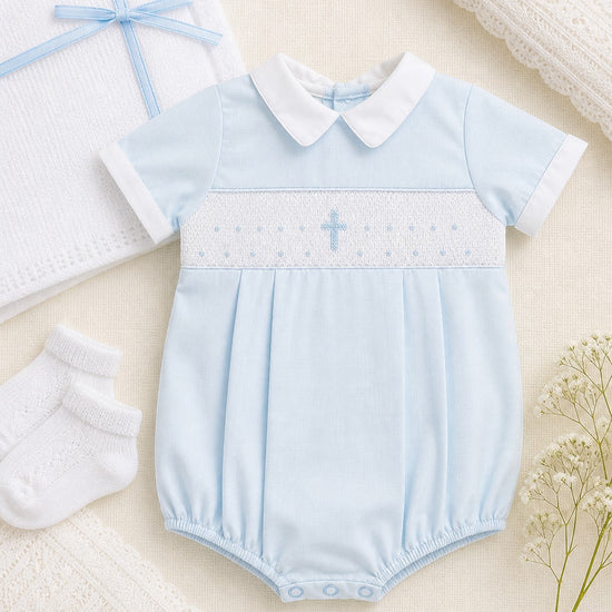 Carriage Boutique blue cotton baby boy bubble romper with white collar and hand-smocked cross detail.