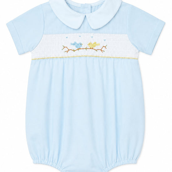 Carriage Boutique light blue baby boy romper with hand-smocked bird and tree embroidery and a classic Peter Pan collar.