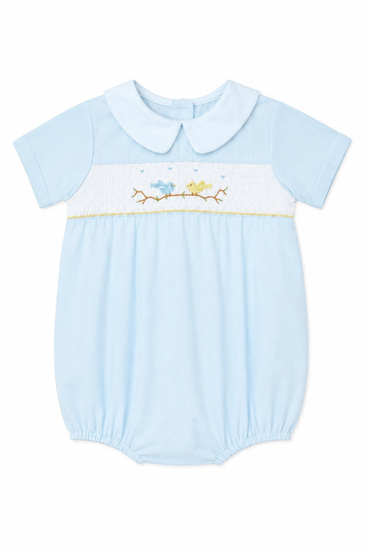 Carriage Boutique light blue baby boy romper with hand-smocked bird and tree embroidery and a classic Peter Pan collar.