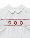 Carriage Boutique boys white batiste shortall with red hand-smocked holiday wreath embroidery and Peter Pan collar.