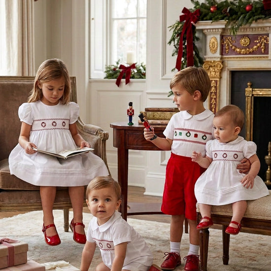 Carriage Boutique boys white batiste shortall with hand-smocked holiday wreath detail for festive seasonal wear.