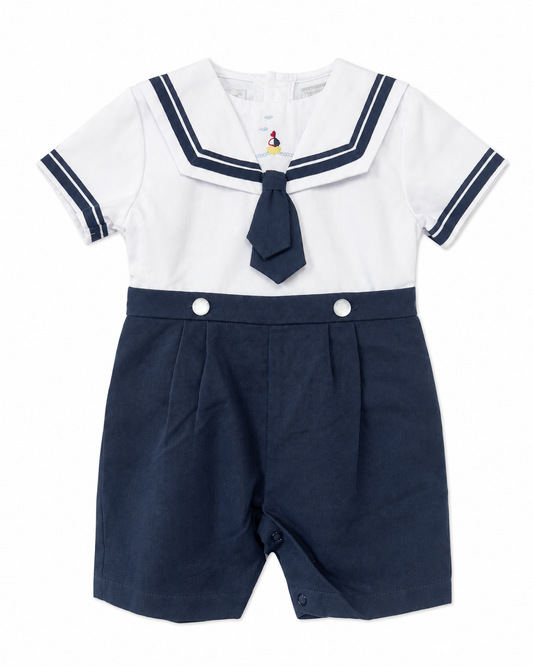 Carriage Boutique boys nautical bobby suit with white cotton shirt, navy sailor collar, tie, and matching shorts.