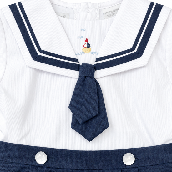 Carriage Boutique boys nautical bobby suit in white pique cotton with navy sailor collar and embroidered sailboat
