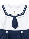 Carriage Boutique boys nautical bobby suit in white pique cotton with navy sailor collar and embroidered sailboat