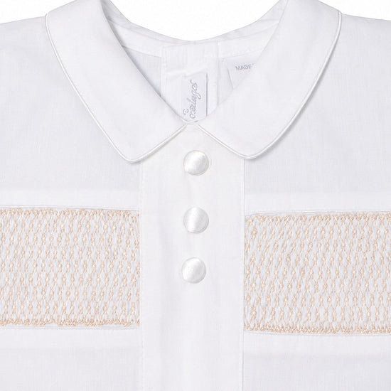 Carriage Boutique white cotton boys christening outfit featuring delicate hand-smocked detail and satin button trim.