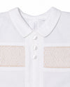 Carriage Boutique white cotton boys christening outfit featuring delicate hand-smocked detail and satin button trim.