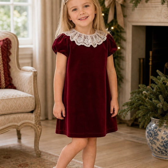 Carriage Boutique burgundy velvet dress for girls featuring a delicate white lace collar and short sleeves.