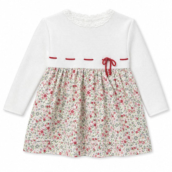 Carriage Boutique long sleeve baby dress with white knit bodice, lace collar, and floral print skirt with red bow.