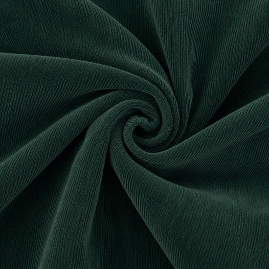 Carriage Boutique dark green cotton corduroy fabric with a soft ribbed texture in a spiral swirl pattern