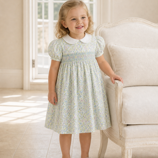 Carriage Boutique toddler girl dress in green floral print with a white Peter Pan collar and smocked bodice.