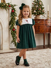 Carriage Boutique toddler girl wearing a dark green velvet holiday dress with a white bib and candy cane embroidery.