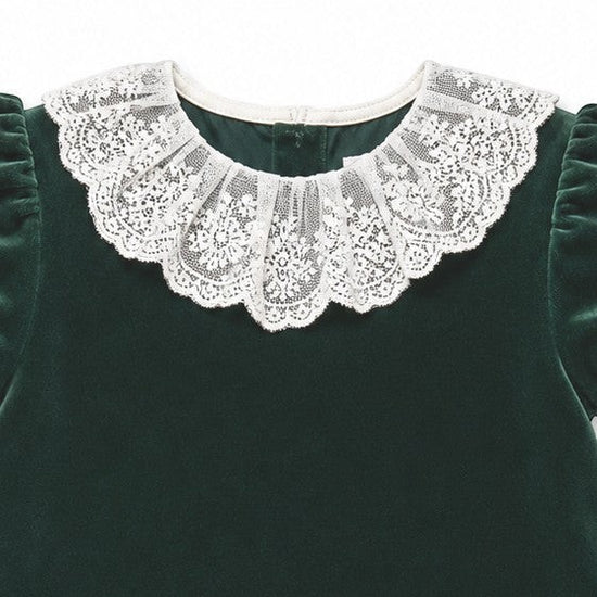 Carriage Boutique green velvet dress featuring an intricate white lace collar and short sleeves.