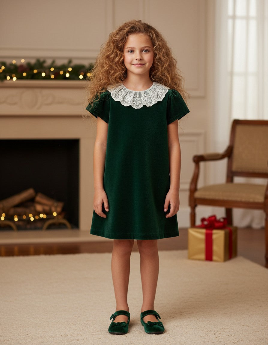 Carriage Boutique toddler green velvet dress with a delicate white lace collar worn by a young girl in a festive room