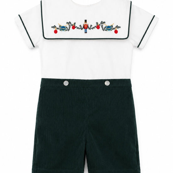 Carriage Boutique infant boy bobbie suit featuring a white shirt with a wooden soldier motif and green corduroy shorts