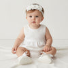 Carriage Boutique ivory lace baptism shoes and chiffon flower headband set worn by a baby girl