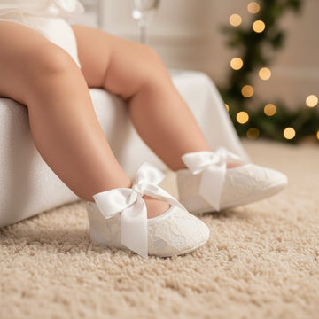 Carriage Boutique ivory lace baby girl baptism shoes with ribbon bows and matching floral headband with pearls.
