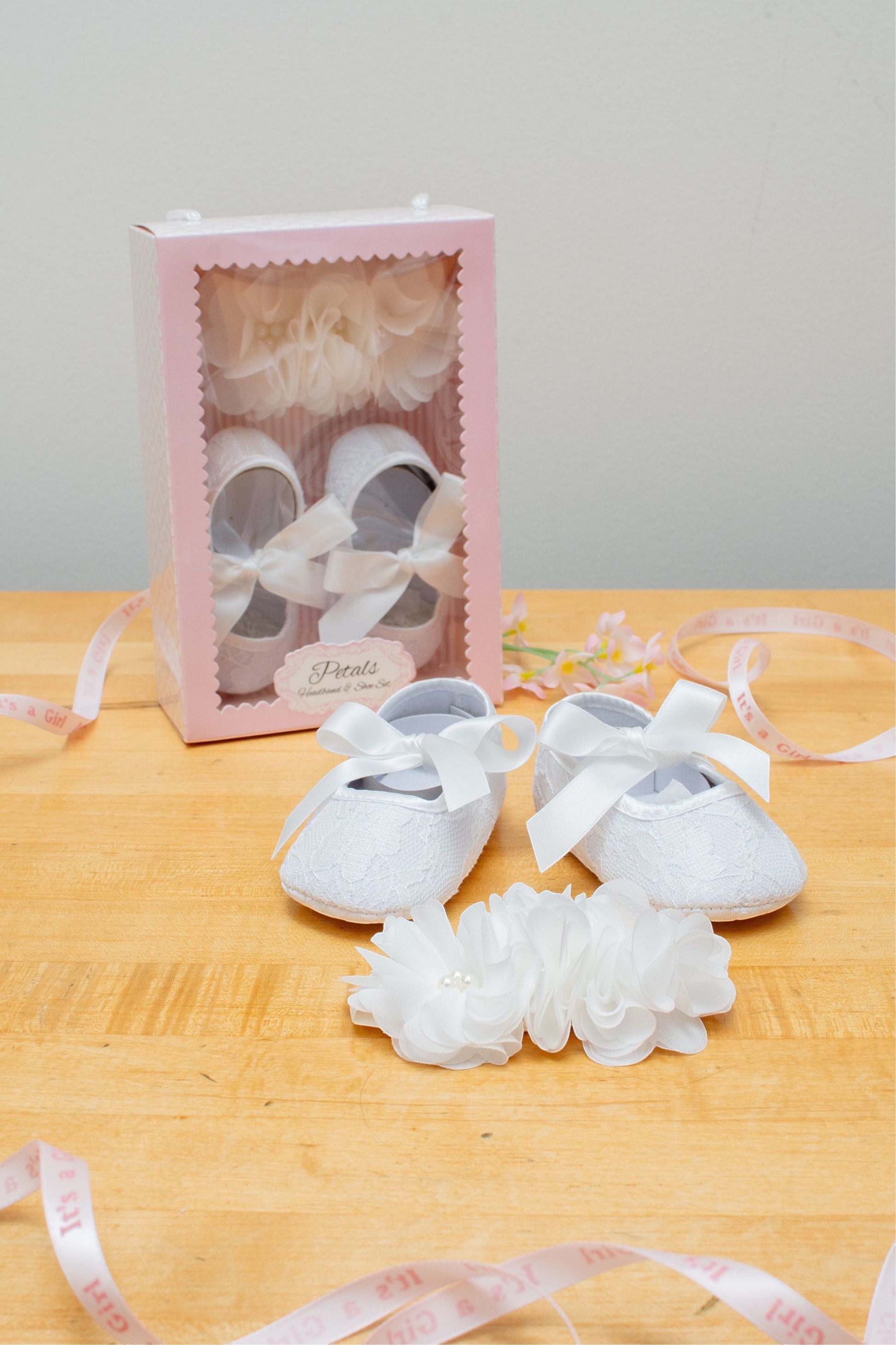 Carriage Boutique ivory lace baby girl baptism shoes with ribbon bows and matching flower headband with pearls.